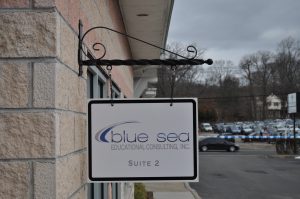 Wilmington Wayfinding Signs outdoor hanging blade sign blue sea building business wayfinding address sign 300x199